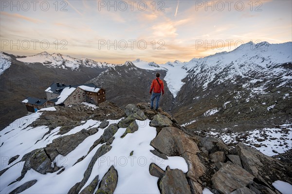 Hiker looking at mountain panorama and glacier