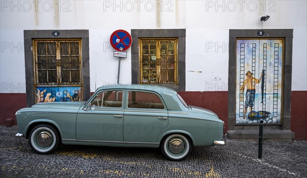 Vintage car in front of a house facade