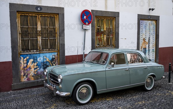 Vintage car in front of a house facade