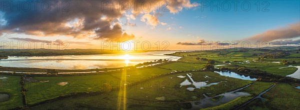 Sunrise over Wetlands and meadows in RSPB Exminster and Powderham Marshe from a drone