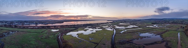 Sunrise over Wetlands and meadows in RSPB Exminster and Powderham Marshe from a drone