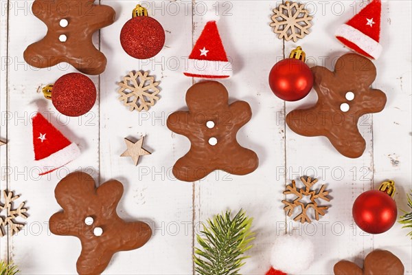 Gingerbread glazed with cocolate in shape of men between Christmas decoration