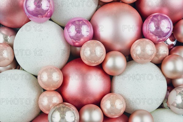 Top view of various pink and white Christmas tree ornament baubles