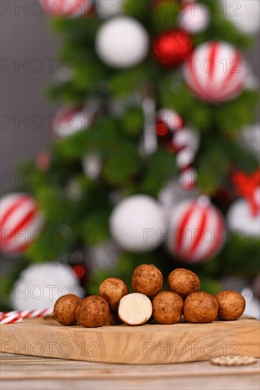 Christmas sweets called 'Marzipankartoffeln'. Round ball shaped almond paste pieces covered in cinnamon and cocoa powder