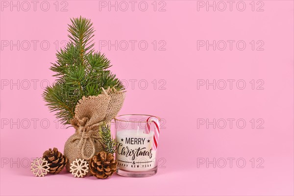 Christmas tree in jute bag with fir cone