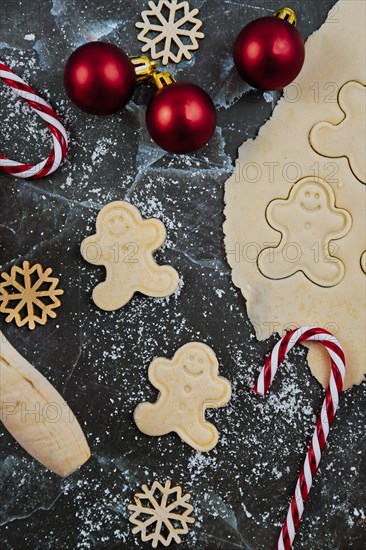 Overhead flat lay concept for baking Christmas cookies with rolled out cookie dough