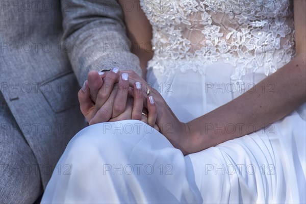 Bride and groom holding hands during the wedding ceremony