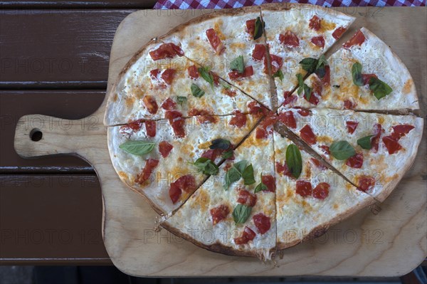 Vegetarian tarte flambee on a wooden board