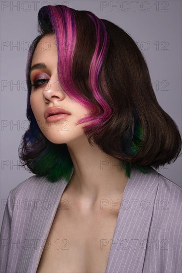 Portrait of beautiful woman with multi-colored hair and classic make up and hairstyle