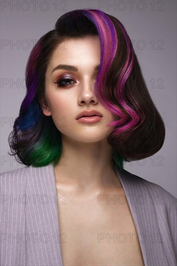 Portrait of beautiful woman with multi-colored hair and classic make up and hairstyle