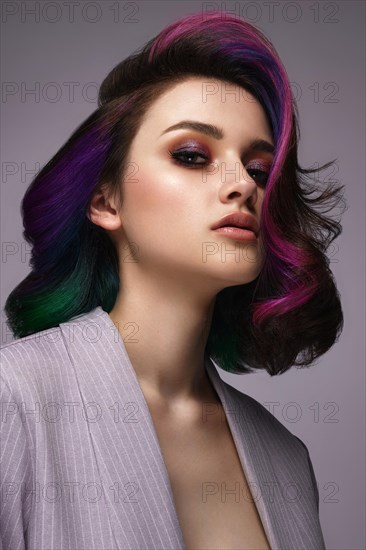 Portrait of beautiful woman with multi-colored hair and classic make up and hairstyle