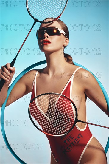 Beautiful attractive woman in a trendy swimsuit with sports equipment and accessories. Fashion photo session. beauty face