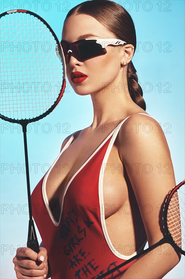 Beautiful attractive woman in a trendy swimsuit with sports equipment and accessories. Fashion photo session. beauty face