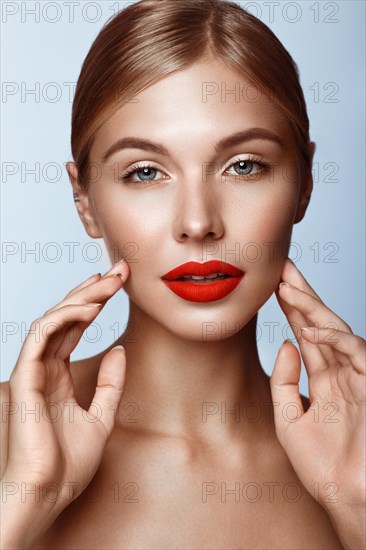 Beautiful girl with red lips and classic makeup. Beauty face. Photo taken in the studio