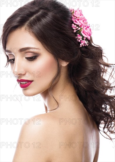 Portrait of a beautiful girl in image of the bride with purple flowers on her head. Beauty face. Photo shot in the Studio on a white background