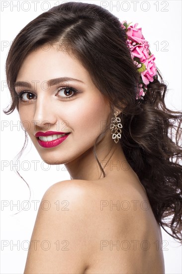 Portrait of a beautiful girl in image of the bride with purple flowers on her head. Beauty face. Photo shot in the Studio on a white background