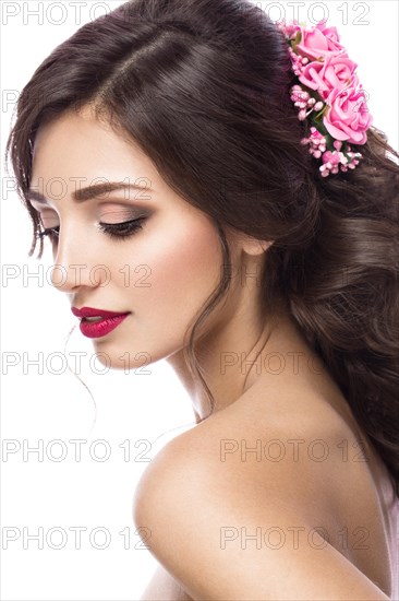 Portrait of a beautiful girl in image of the bride with purple flowers on her head. Beauty face. Photo shot in the Studio on a white background