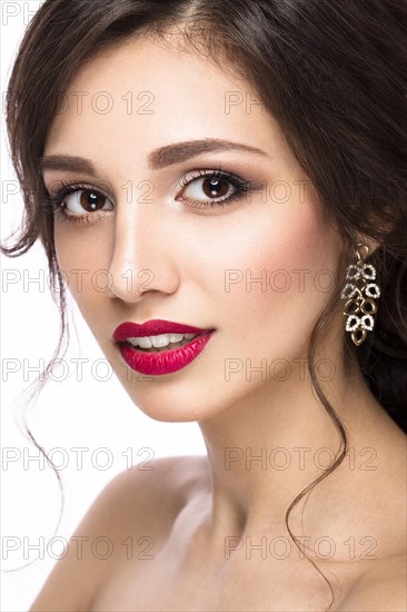 Portrait of a beautiful girl in image of the bride with purple flowers on her head. Beauty face. Photo shot in the Studio on a white background