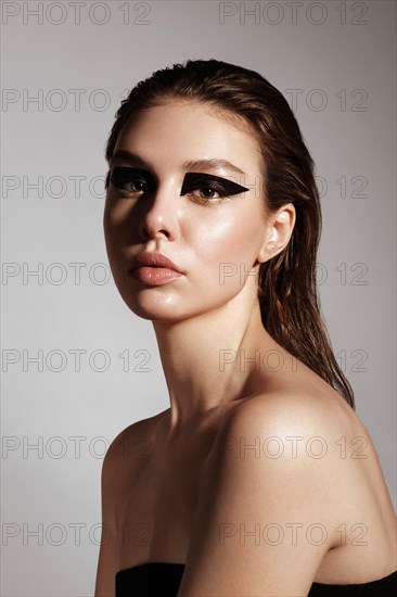 Portrait of a beautiful woman in a rock style image with creative makeup and hairstyle