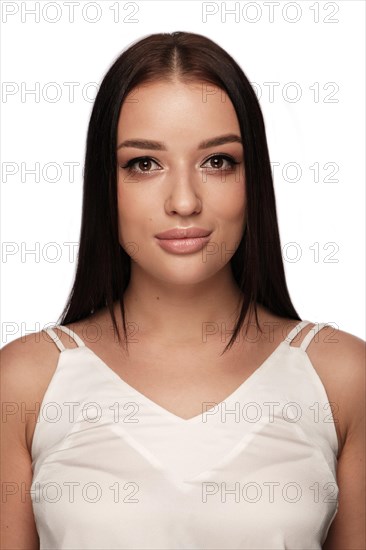 Beautiful brown-haired girl with smooth hair and classic make-up. Photo on the document. Picture taken in the studio
