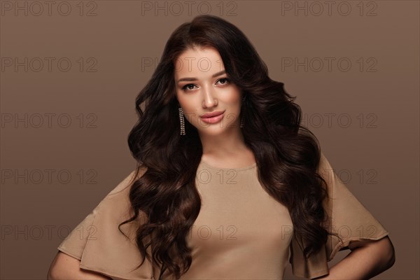 Beautiful brown-haired girl with a perfectly curls hair