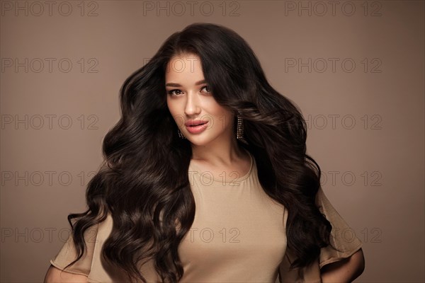 Beautiful brown-haired girl with a perfectly curls hair