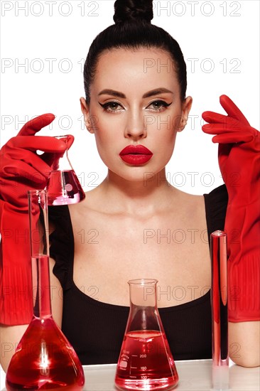 Beautiful woman with laboratory containers with liquid