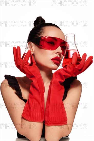 Beautiful woman with laboratory containers with liquid