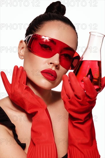 Beautiful woman with laboratory containers with liquid