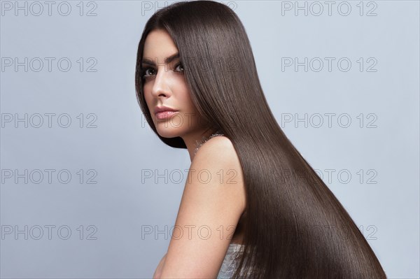 Beautiful brown-haired girl with a perfectly smooth hair