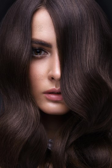 Beautiful brown-haired girl with a perfectly curls hair