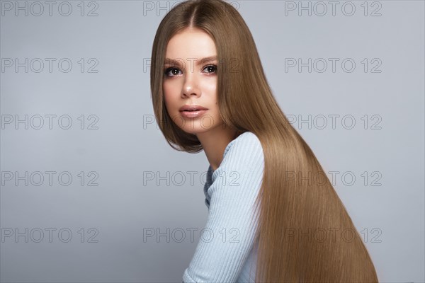 Beautiful blond girl with a perfectly smooth hair