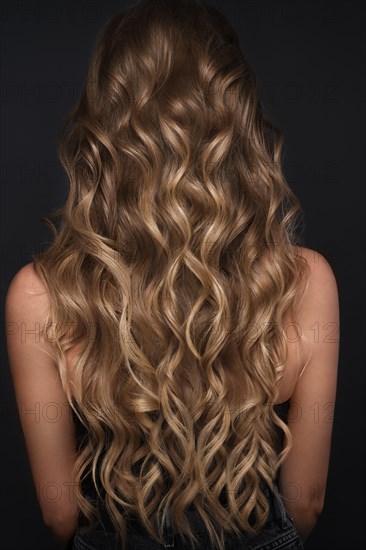 A closeup view of a bunch of shiny curls blond hair