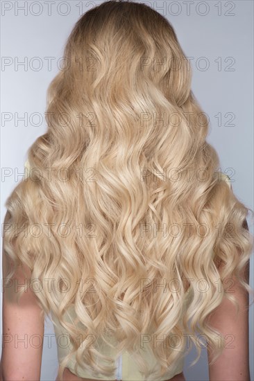 A closeup view of a bunch of shiny curls blond hair