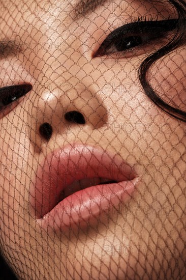 Portrait of beautiful asian woman with mesh on face and makeup. Beauty face. Close-up