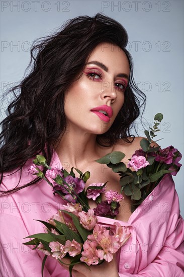 Beautiful brunette girl with a gentle pink romantic make-up