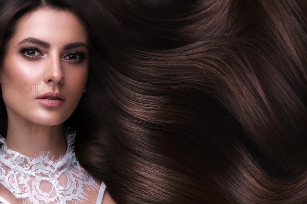 Beautiful brown-haired girl with a perfectly curls hair