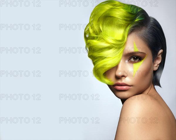 Portrait of beautiful woman with multi-colored hair and creative make up and hairstyle