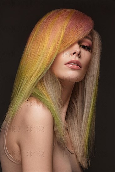 Portrait of beautiful woman with multi-colored hair and classic make up and hairstyle