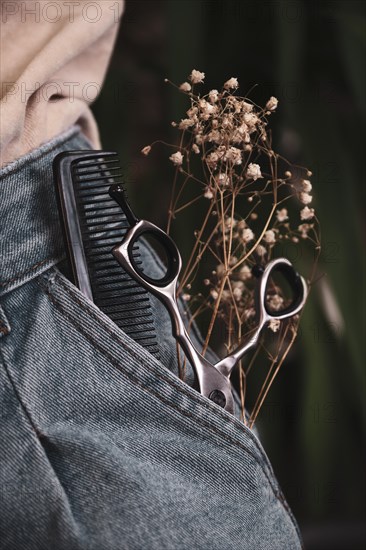 Hairdressing tools close-up in jeans with flowers