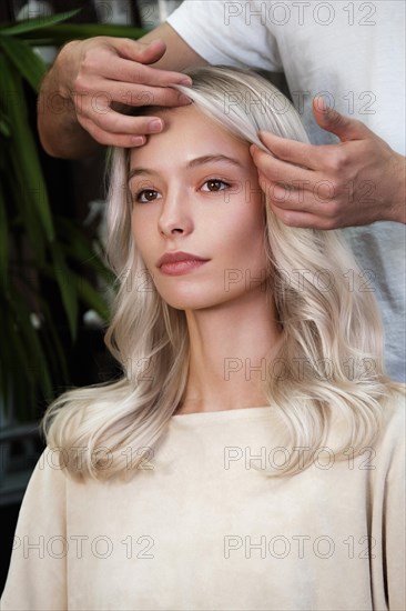 Young woman in a hairdressing salon dyes her hair blond. beauty face and hair