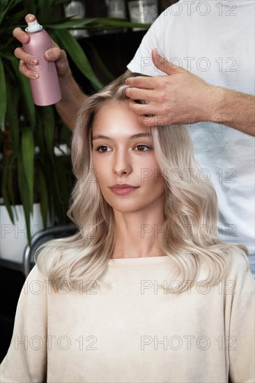 Young woman in a hairdressing salon dyes her hair blond. beauty face and hair