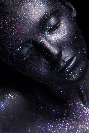 Portrait of beautiful woman with art glitter makeup on her face