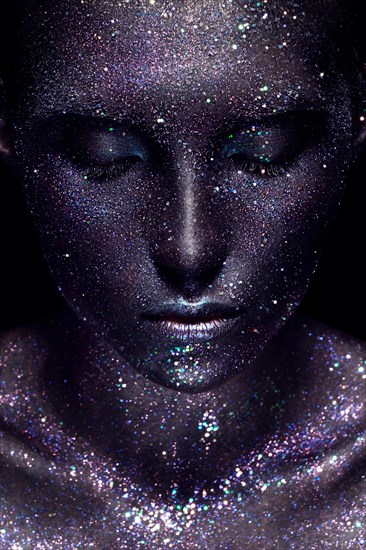 Portrait of beautiful woman with art glitter makeup on her face