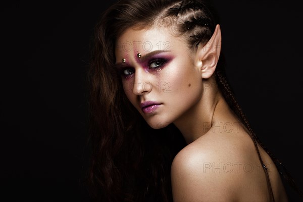 Brunette girl with a creative hairstyle braids