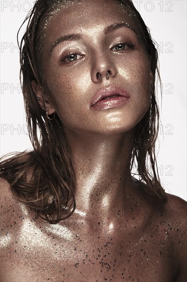 Portrait of beautiful woman with art glitter makeup on her face