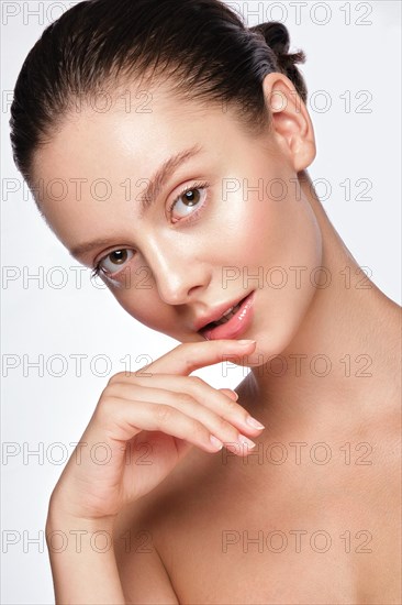 Portrait of beautiful woman with light natural make-up and perfect skin