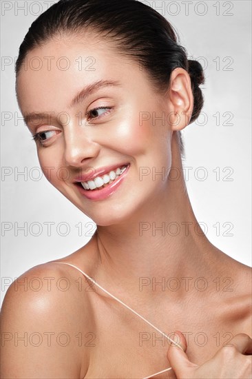 Portrait of beautiful woman with light natural make-up and perfect skin