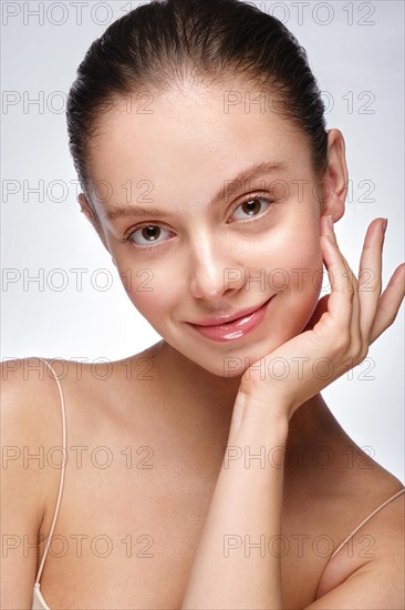 Portrait of beautiful woman with light natural make-up and perfect skin