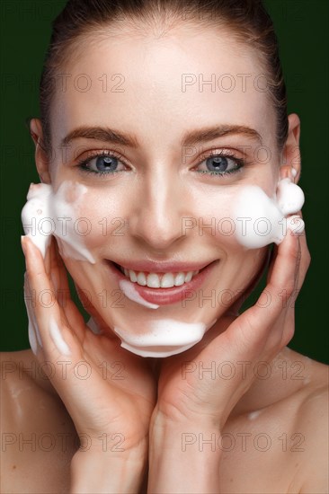 Beautiful young girl with facial wash on the skin. Beauty face. Picture taken in the studio